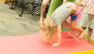 Toddler doing a forward roll